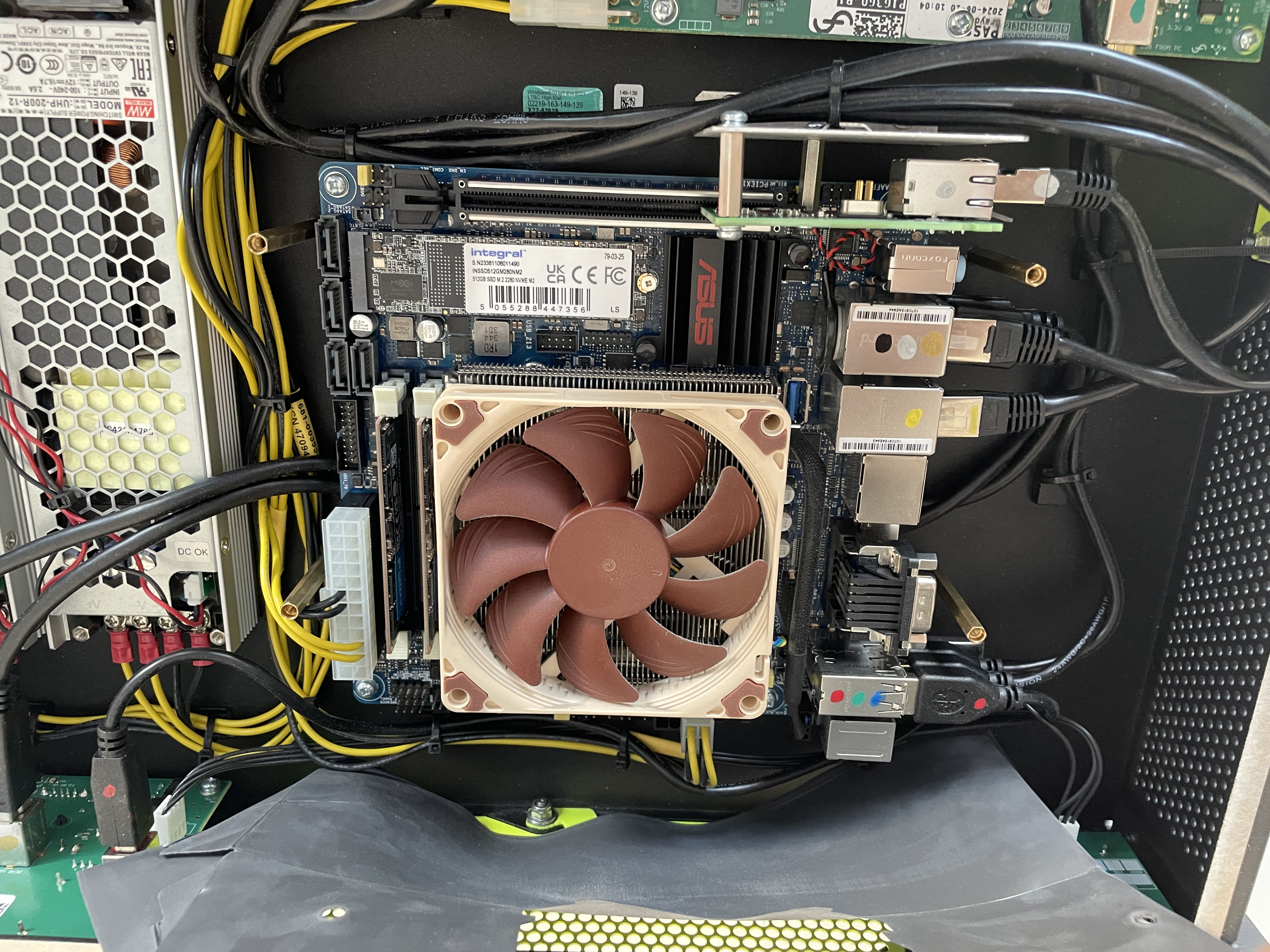 The Noctua fan with its four mounting screws removed